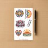 Sticker sheet with six colorful designs including a smiling sun with flowers, retro rainbow Spread Negativity, floral rainbow Bad Vibes Only, vertical I could be meaner text, heart Silently Screaming inside, and sunburst Please Don’t Talk To Me.